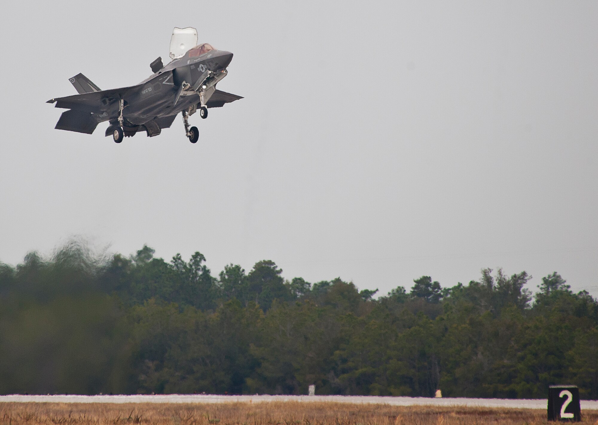 Royal Air Force pilot, Squadron Leader Hugh Nichols, lifts off in a Marine F-35B Lightning II for the first short take-off and vertical landing sortie by a United Kingdom pilot at Eglin Air Force Base, Fla., Feb. 25.  The U.S. Marines began flying STOVL sorties at Eglin in October 2013.  (U.S. Air Force photo/Samuel King Jr.)