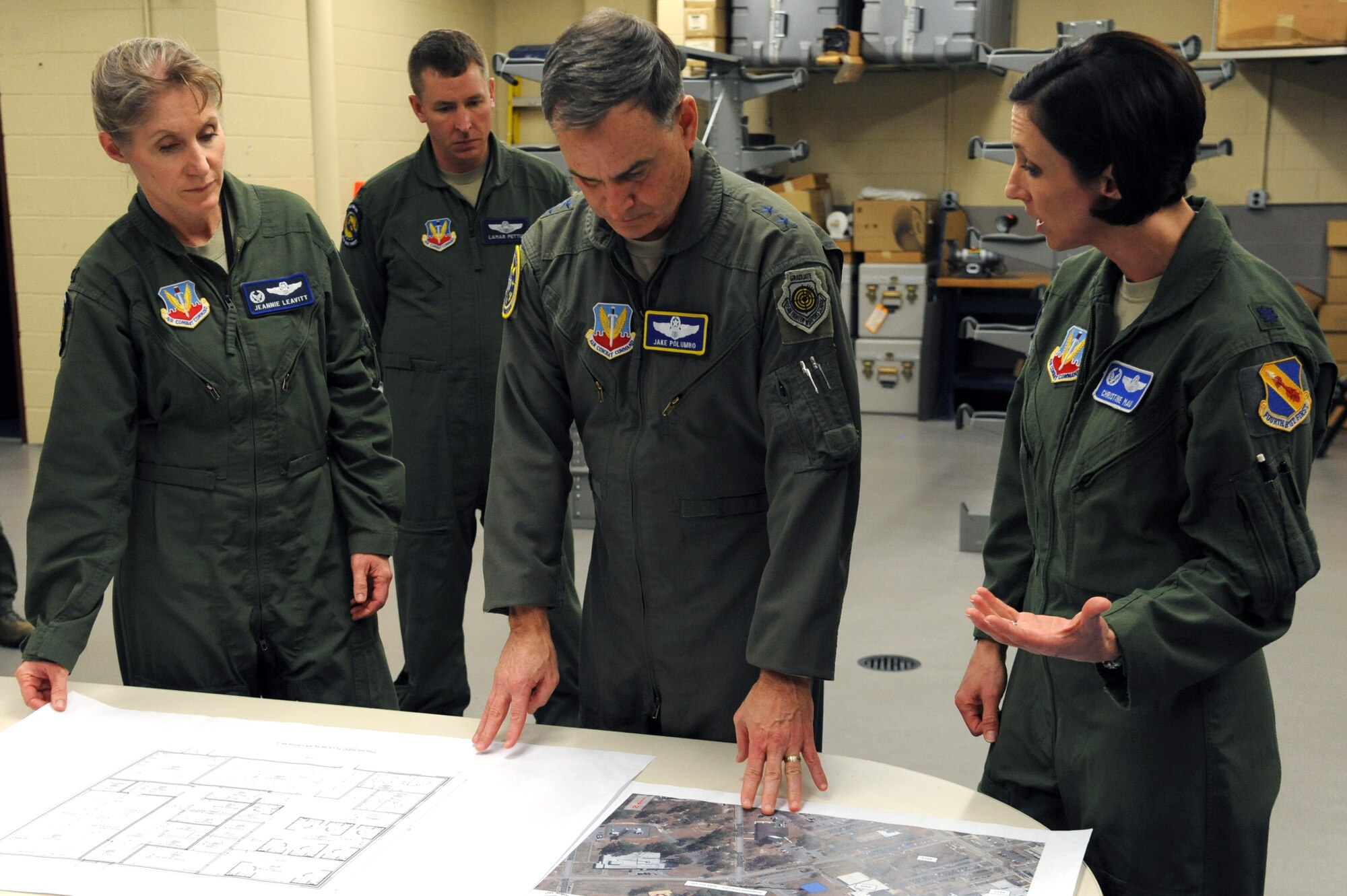 Lt. Col. Christine Mau (far right), 4th Operations Support Squadron commander, presents plans for a new operations center to Maj. Gen. Jake Polumbo (middle), Ninth Air Force commander, as Col. Jeannie Leavitt (left), 4th Fighter Wing commander, looks on, Feb. 20, 2014, at Seymour Johnson Air Force Base, N.C. Mau explained the needs for new facilities to assist 4th FW operations and exercises. (U.S. Air Force photo by Airman 1st Class Aaron J. Jenne)