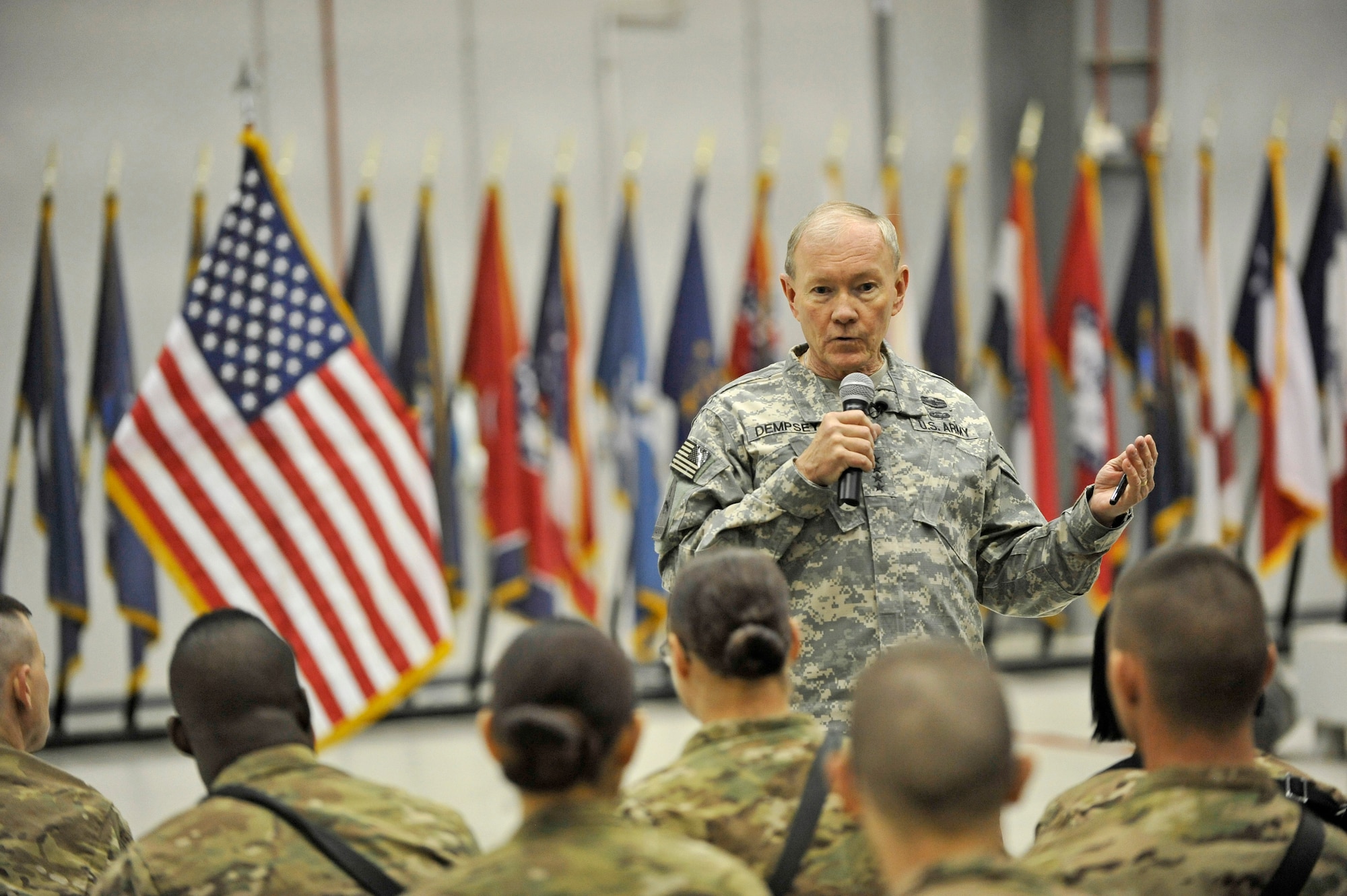 U.S. Army Gen. Martin E. Dempsey, chairman of the Joint Chiefs of Staff, answers a question from a Service member at Bagram Airfield, Afghanistan, Feb. 26, 2014. Dempsey hosted a town hall meeting where he answered questions ranging from the future of U.S. military operations in Afghanistan to force reduction measures.(U.S. Air Force photo by Senior Master Sgt. Gary J. Rihn/Released)