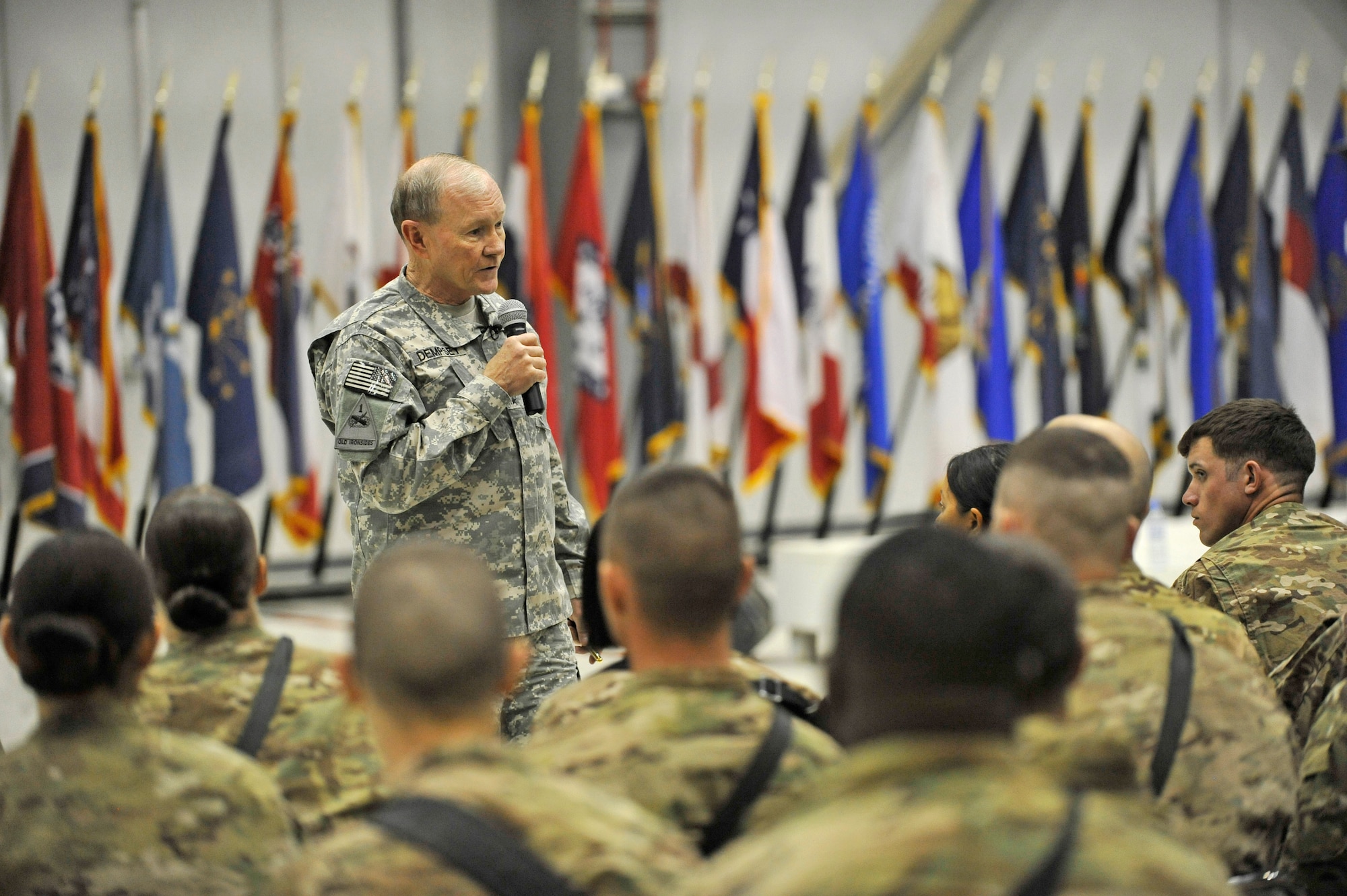 U.S. Army Gen. Martin E. Dempsey, chairman of the Joint Chiefs of Staff, talks about operating with fewer Service members in the future at a town hall meeting at Bagram Airfield, Afghanistan, Feb. 26, 2014. Dempsey answered questions ranging from the future of U.S. military operations in Afghanistan to force reduction measures.(U.S. Air Force photo by Senior Master Sgt. Gary J. Rihn/Released)