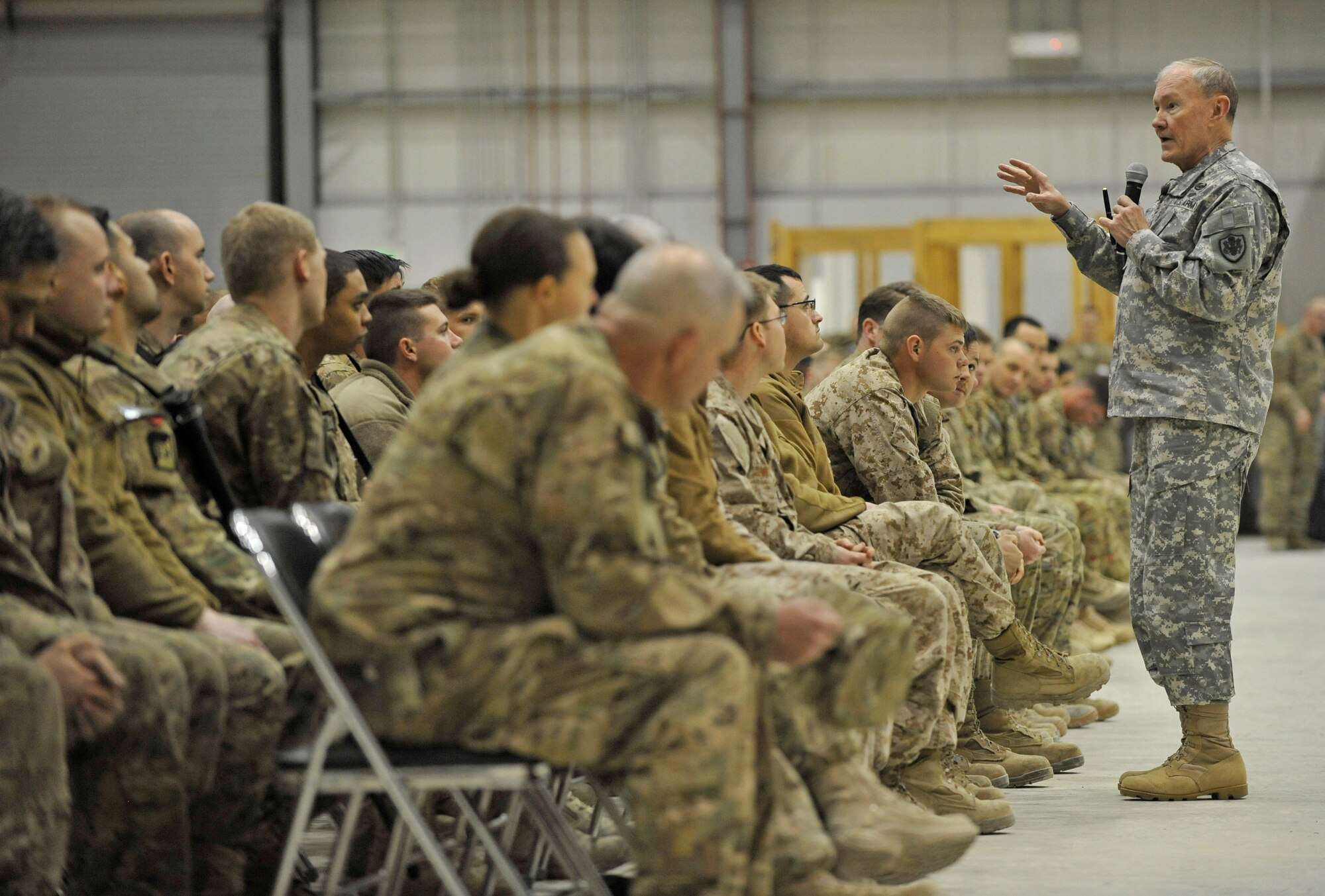 U.S. Army Gen. Martin E. Dempsey, chairman of the Joint Chiefs of Staff, talks to Service members at a town hall meeting at Bagram Airfield, Afghanistan, Feb. 26, 2014. Dempsey answered questions ranging from the future of U.S. military operations in Afghanistan to force reduction measures.(U.S. Air Force photo by Senior Master Sgt. Gary J. Rihn/Released)(photo was cropped to emphasize subject)