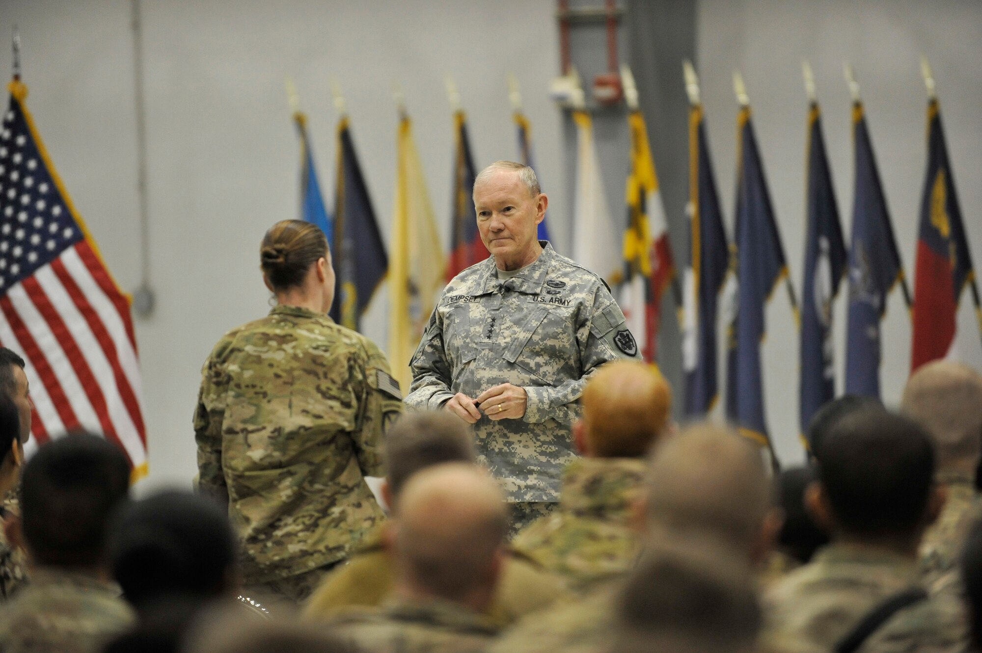 U.S. Army Gen. Martin E. Dempsey, chairman of the Joint Chiefs of Staff, listens to a question from a Service member at Bagram Airfield, Afghanistan, Feb. 26, 2014. Dempsey hosted a town hall meeting where he answered questions ranging from the future of U.S. military operations in Afghanistan to force reduction measures.(U.S. Air Force photo by Senior Master Sgt. Gary J. Rihn/Released)