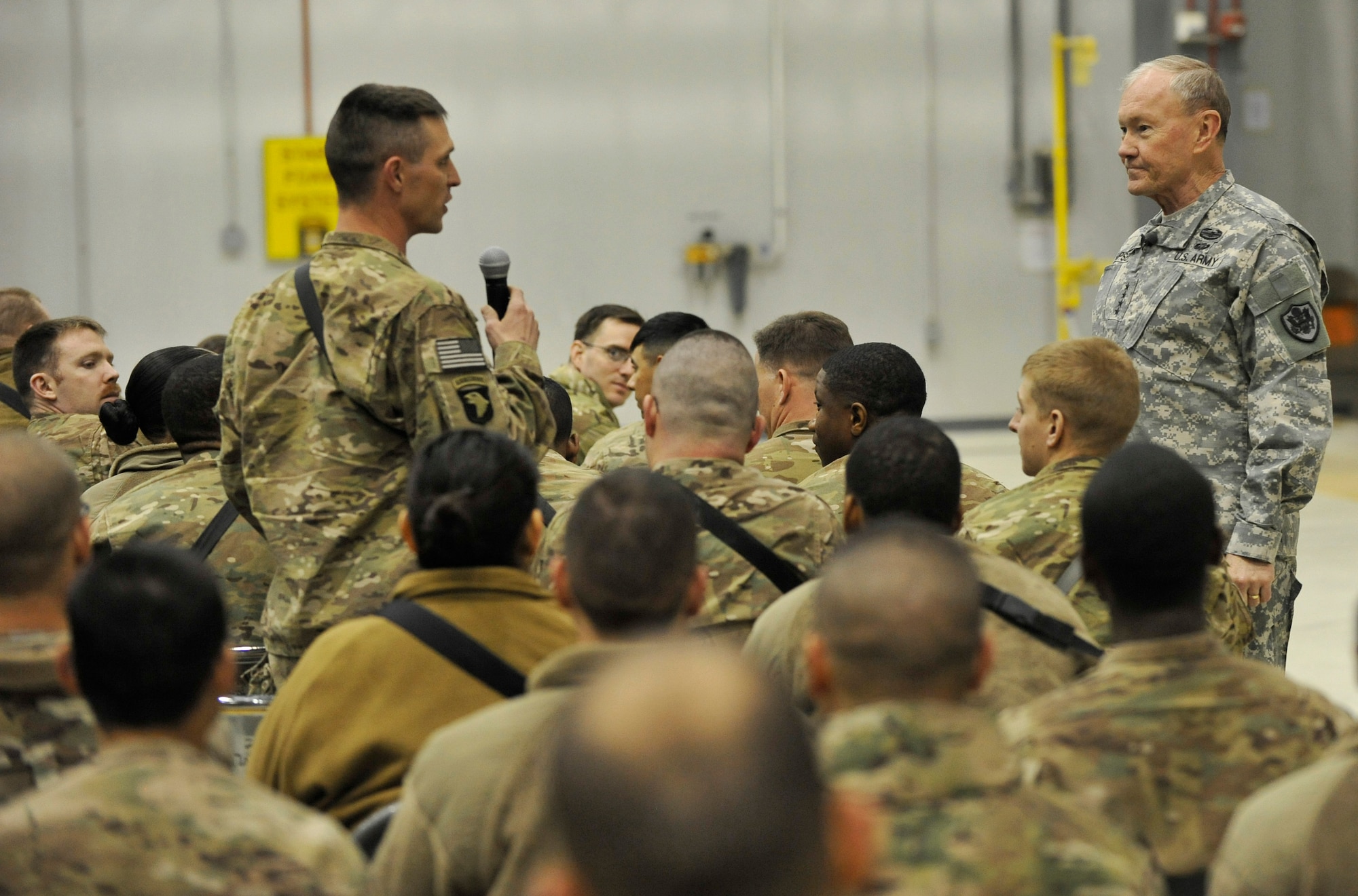 U.S. Army Gen. Martin E. Dempsey, chairman of the Joint Chiefs of Staff, listens to a question from a Service member at Bagram Airfield, Afghanistan, Feb. 26, 2014. Dempsey hosted a town hall meeting where he answered questions ranging from the future of U.S. military operations in Afghanistan to force reduction measures.(U.S. Air Force photo by Senior Master Sgt. Gary J. Rihn/Released)(photo was cropped to emphasize subject)