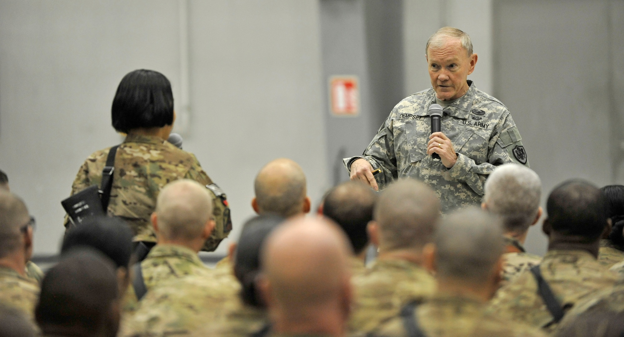 U.S. Army Gen. Martin E. Dempsey, chairman of the Joint Chiefs of Staff, listens to a question from a Service member at Bagram Airfield, Afghanistan, Feb. 26, 2014. Dempsey hosted a town hall meeting where he answered questions ranging from the future of U.S. military operations in Afghanistan to force reduction measures.(U.S. Air Force photo by Senior Master Sgt. Gary J. Rihn/Released)(photo was cropped to emphasize subject)