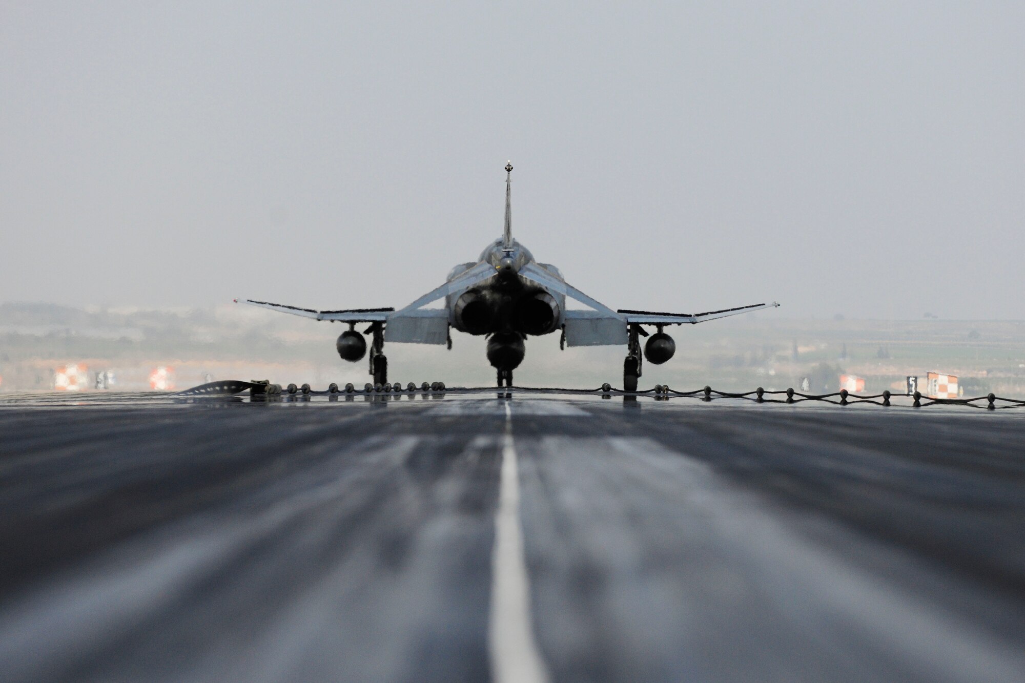 A Turkish air force F-4 Phantom waits at the end of the runway after catching the barrier on a BAK-12 aircraft arresting system during an annual test Feb. 24, 2014, Incirlik Air Base, Turkey. Aircraft arresting systems are used to rapidly decelerate an aircraft as it lands.  (U.S. Air Force photo by Senior Airman Nicole Sikorski/Released) 