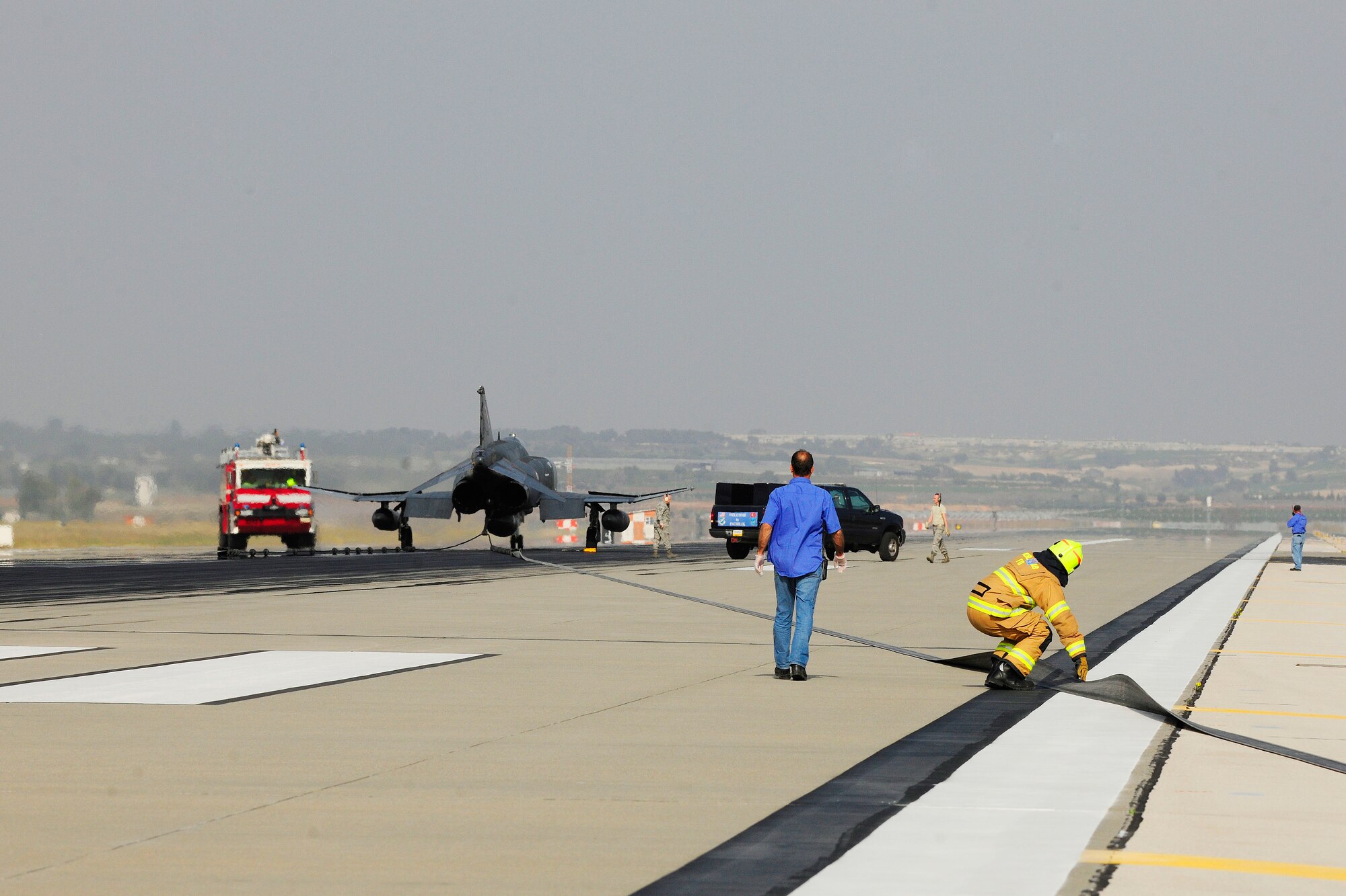 Airmen assigned to the 39th Operations Squadron and the 39th Civil Engineer Squadron inspect the integrity of cables on a BAK-12 aircraft arresting barrier system Feb. 24, 2014, Incirlik Air Base, Turkey.  The annual test is just one example of how Turkish air force and U.S. Air Force service members partner together to ensure mission readiness at Incirlik AB. (U.S. Air Force photo by Senior Airman Nicole Sikorski/Released) 