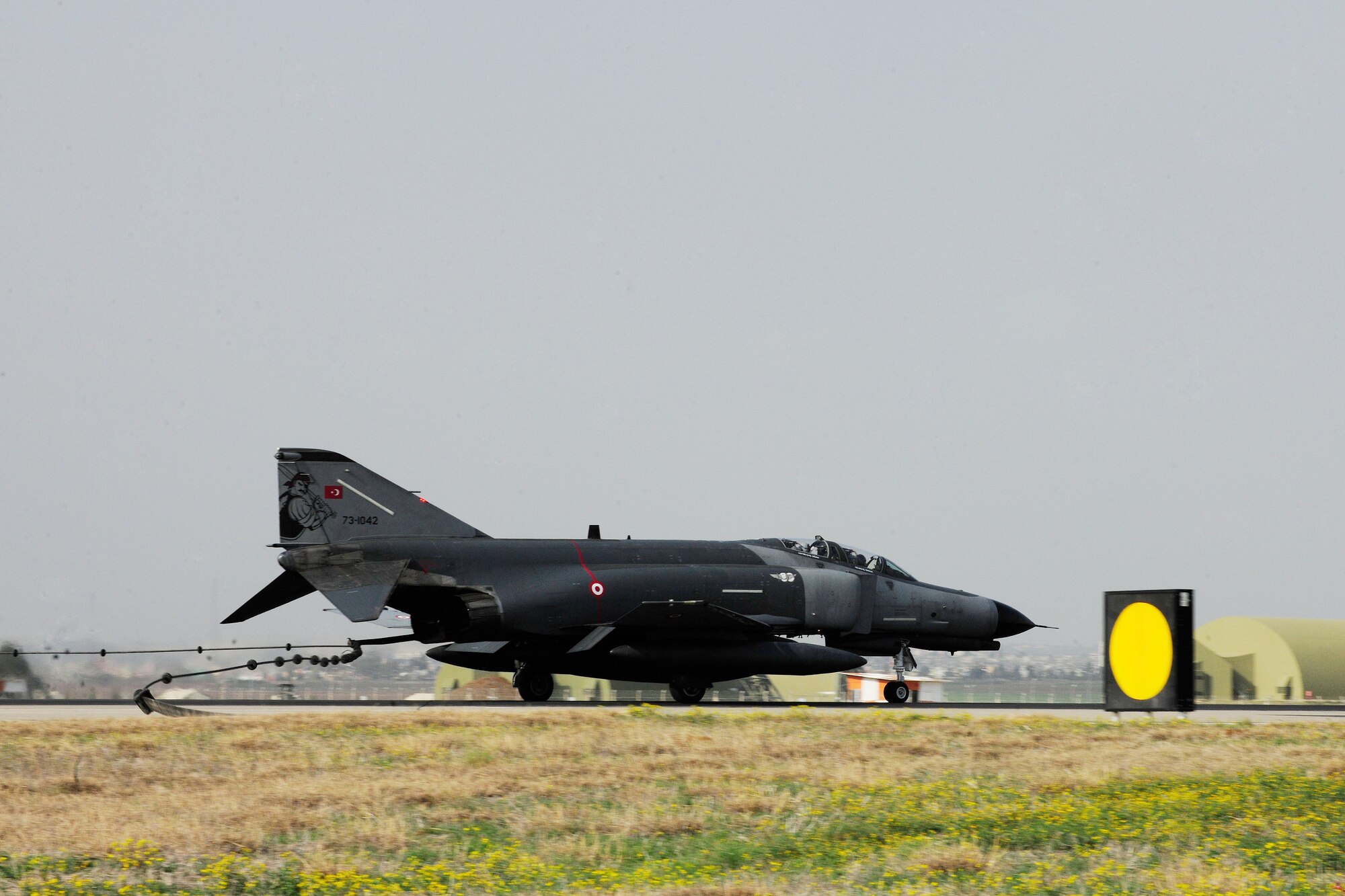 A Turkish air force F-4 Phantom drops its tail hook to catch the barrier on a BAK-12 aircraft arresting system during an annual test Feb. 24, 2014, Incirlik Air Base, Turkey.  The U.S. Air Force has mandated aircraft arresting systems like the BAK-12 to all airfields supporting fighter and training aircraft. (U.S. Air Force photo by Senior Airman Nicole Sikorski/Released) 
