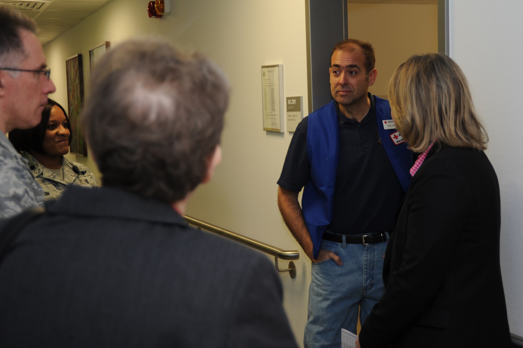 Jose Tamayo, an American Red Cross volunteer, center right, meets with Sherri Brown, senior vice president of the American Red Cross' Service to the Armed Forces, far right, during a tour of the 52nd Medical Group facility Feb. 25, 2014, at Spangdahlem Air Base, Germany. During the tour, Brown met and thanked Red Cross volunteers for their continued support. (U.S. Air Force photo by Airman 1st Class Dylan Nuckolls/Released)