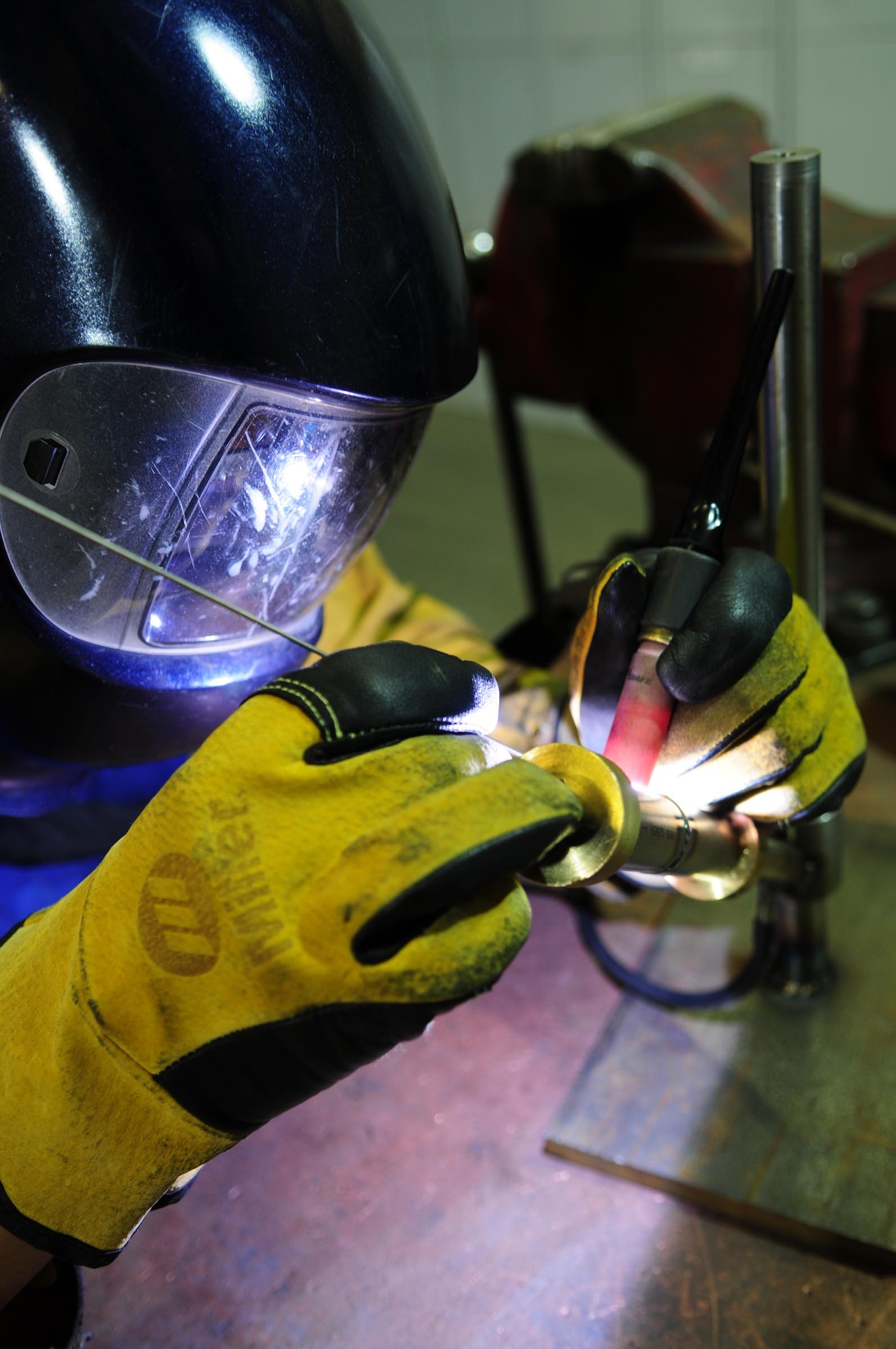 U.S. Air Force Senior Airman William Huff, 100th Maintenance Squadron Aircraft Metals Technology journeyman from Baltimore, uses tungsten welding rods to perform weld certification on a titanium tube Feb. 17, 2014, in Hangar 814 on RAF Mildenhall, England. Once Aircraft Metals Technology Airmen earn their five-level qualification, they must accomplish certification training every five years. Technicians in AMT can both repair and manufacture machined, non-procurable aircraft components. (U.S. Air Force photo by Karen Abeyasekere/Released)