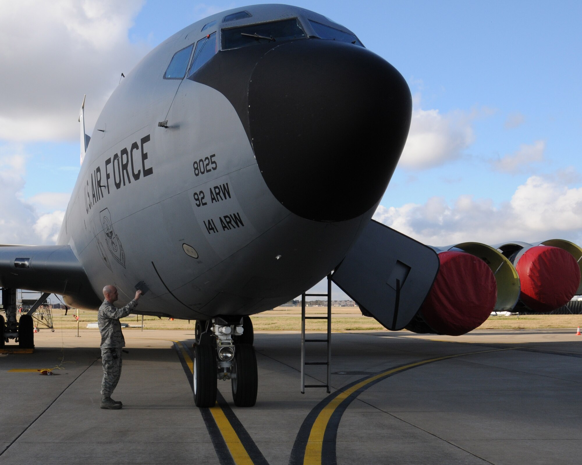 U.S. Air Force Tech. Sgt. Shannon Brooks, 100th Aircraft Maintenance Squadron production expeditor from Folio, Calif., checks for servicing requirements on a KC-135 Stratotanker Feb. 19, 2014, on RAF Mildenhall, England. Brooks improved the wash rack program by establishing a team structure, ensuring the wash teams had transportation and adequate tools, and he also implemented a 30-day wash cycle. The wash protects the aircraft from corrosion damage and is just like washing a vehicle, with hoses, brushes and soap. (U.S. Air Force photo by Gina Randall/Released)