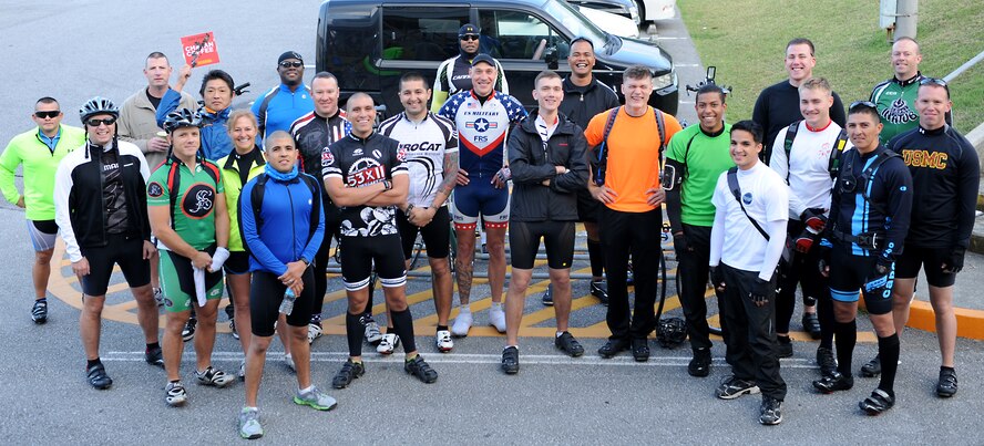 Participants in the 24-hour honor ride take a group photo before beginning their ride on Marine Corps Camp Foster, Japan, Feb. 22, 2014. Approximately 26 riders participated in the 24-hour honor ride, some accomplishing 200 miles around the island within the 24-hour period. (U.S. Air Force photo by Airman 1st Class Hailey R. Staker)