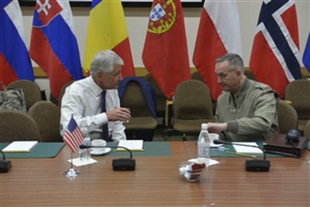 U.S. Defense Secretary Chuck Hagel meets with U.S. Marine Corps Gen. Joseph F. Dunford Jr. commander of the International Security Assistance Force in Afghanistan, while attending meetings for NATO defense ministers in Brussels, Feb. 26, 2014.