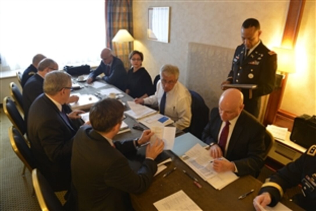U.S. Defense Secretary Chuck Hagel attends a morning meeting with staff members before departing his hotel to attend a NATO defense ministerial meeting in Brussels, Feb. 26, 2014.