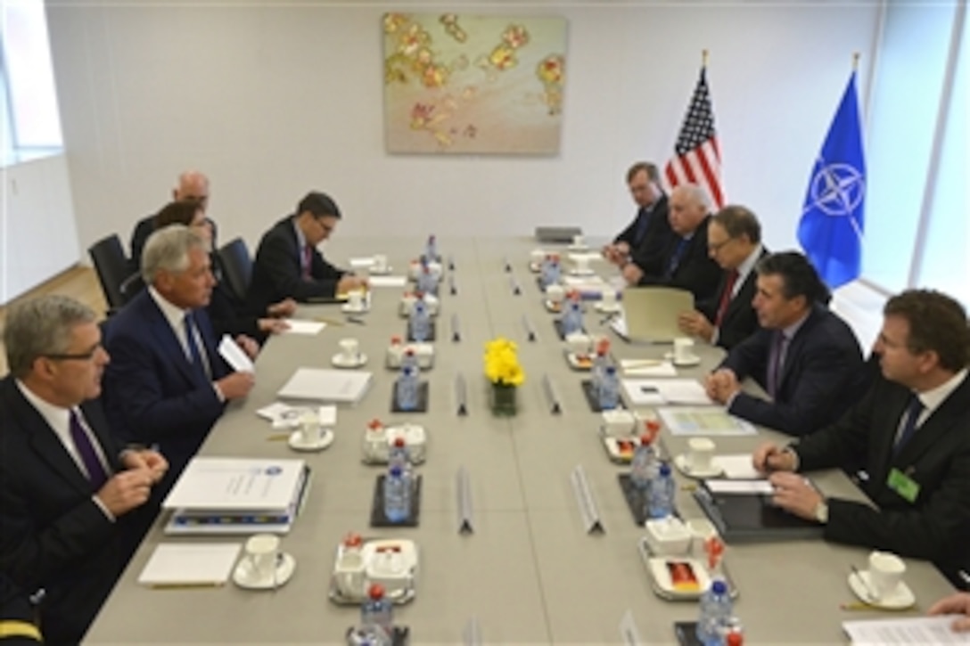 U.S. Defense Secretary Chuck Hagel, center left, meets with NATO Secretary General Anders Fogh Rasmussen, center right, during NATO defense ministerial meetings in Brussels, Feb. 26, 2014.