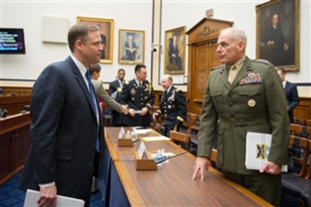 Marine Corps Gen. John F. Kelly, commander of U.S. Southern Command, talks with U.S. Rep. Jim Bridenstine of Oklahoma after testifying before the House Armed Services Committee in Washington, D.C., Feb. 26, 2014.