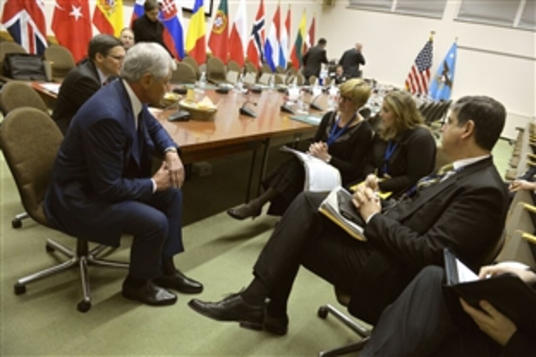 U.S. Defense Secretary Chuck Hagel, left, hosts a small meeting with Italian Defense Minister Roberta Pinotti during the meetings for NATO defense ministers in Brussels, Feb. 26, 2014. 
