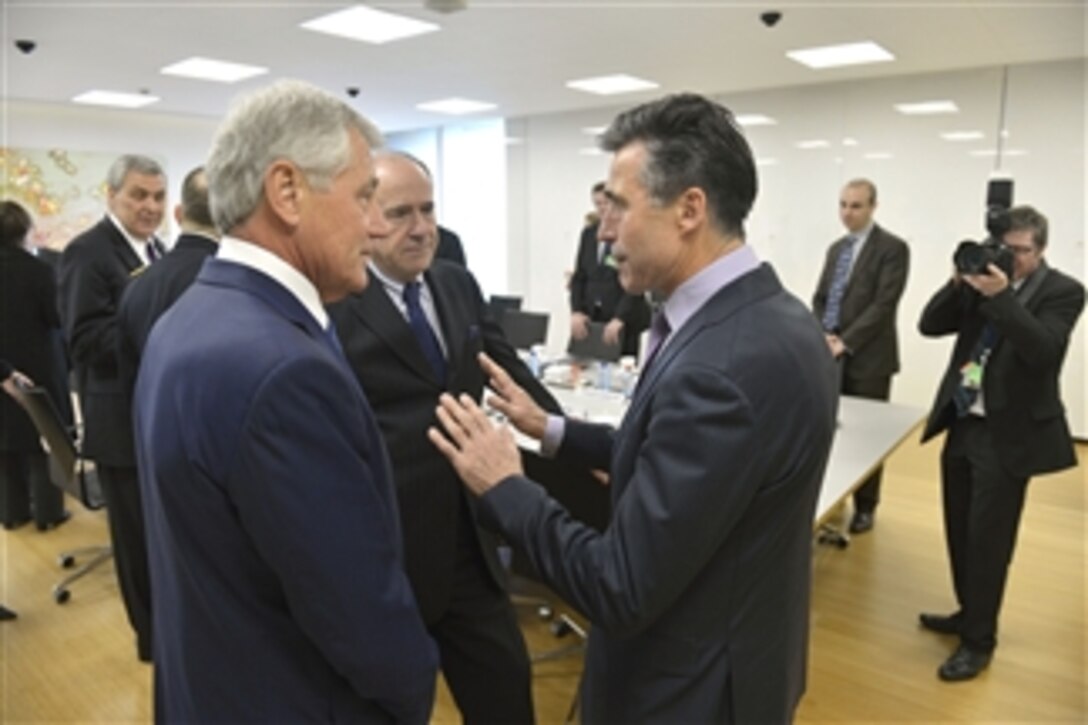 U.S. Defense Secretary Chuck Hagel, left, meets with NATO Secretary General Anders Fogh Rasmussen as he attends meetings for NATO defense ministers in Brussels, Feb. 26, 2014.