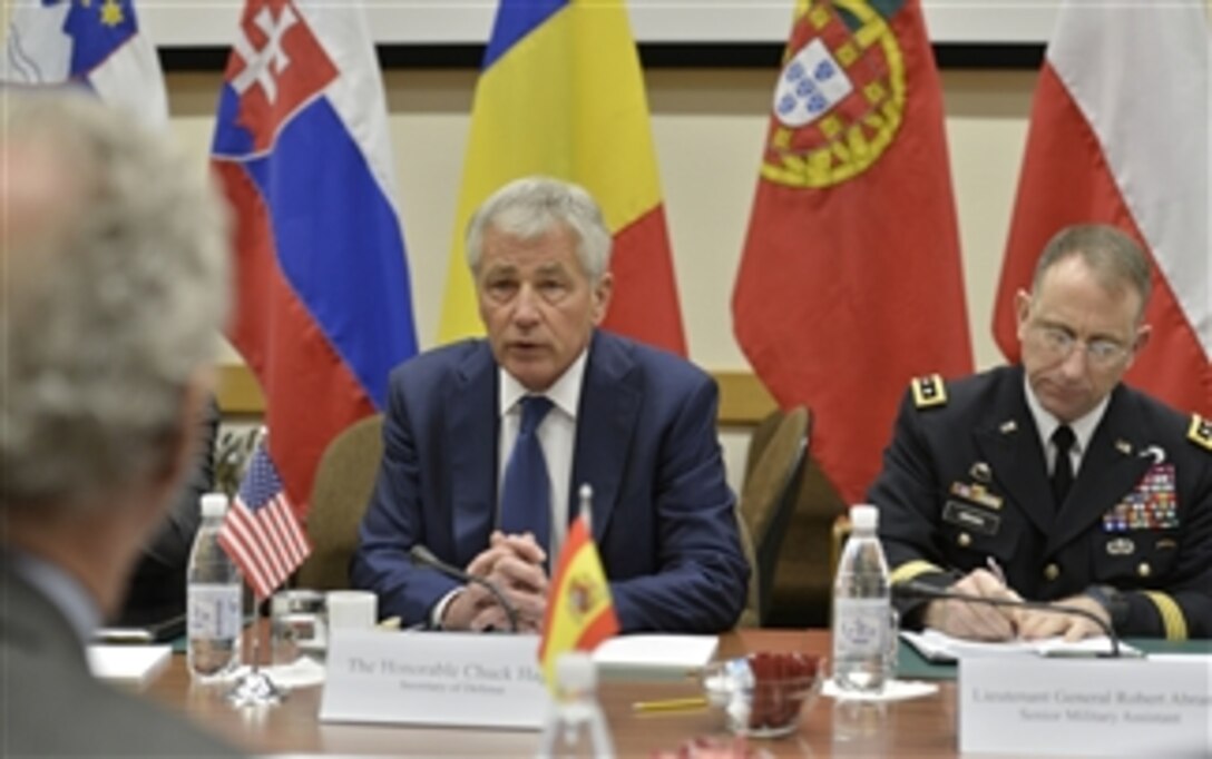 U.S. Defense Secretary Chuck Hagel, center, meets with Spanish Defense Minister Pedro Morenés Eulate, left foreground, as he attends meetings for NATO defense ministers in Brussels, Feb. 26, 2014.
