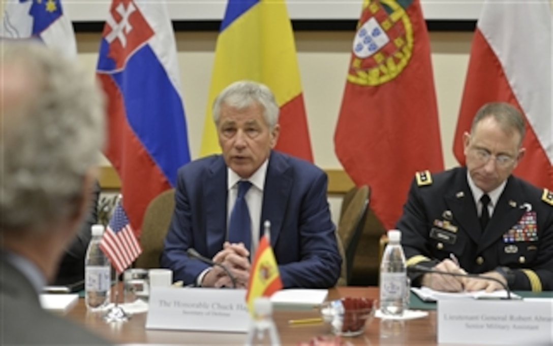 U.S. Defense Secretary Chuck Hagel, center, meets with Spanish Defense Minister Pedro Morenés Eulate, left foreground, as he attends meetings for NATO defense ministers in Brussels, Feb. 26, 2014.