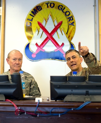 Army Maj. Gen. Stephen J. Townsend, commander of CJTF-10 and 10th Mountain Division, briefs Gen Martin E. Dempsey, chairman of the Joint Chiefs of Staff, about local operations in Regional East Headquarters on Bagram Air Base, Afghanistan, Feb. 26, 2014. Dempsey is in Afghanistan to visit troops and commanders.