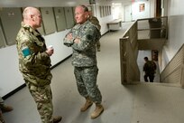 British Army Lt. Gen. John Lorimer, ISAF deputy commander, and Gen. Martin E. Dempsey, chairman of the Joint Chiefs of Staff, talk in between meetings at ISAF Regional East Headquarters on Bagram Air Base, Afghanistan, Feb. 26, 2014. Dempsey is in Afghanistan to visit troops and commanders to assess mission status.