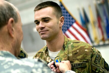 Gen. Martin E. Dempsey, chairman of the Joint Chiefs of Staff, awards an Air Medal to a Soldier at Bagram Air Base, Afghanistan, Feb. 26, 2014. Dempsey is in Afghanistan to visit troops and commanders to assess mission status.