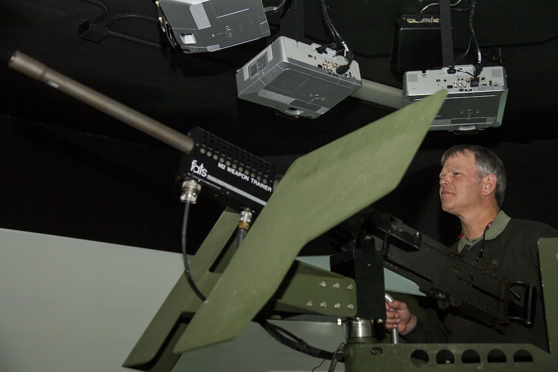 Herbert Gaines, a state board member of the Farm Bereau Association, participates in a urban terrain combat simulation,at the Simulation Integration Center, aboard Marine Corps Base Camp Lejeune, Feb. 24. The puprose of the visit was to gain a better understanding of the Marine Corps in hopes of forming a charitable partnership.  