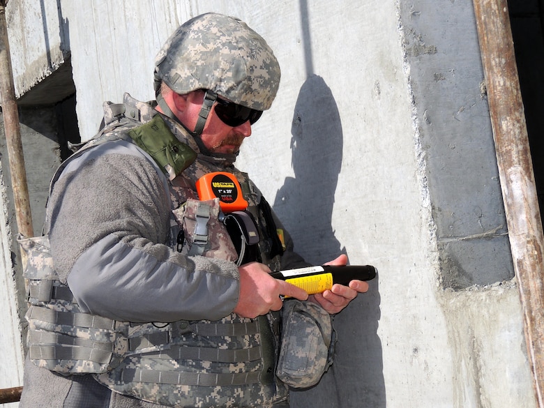 Chuck Hadley tests the concrete strength using a concrete impact at a Logar Province project. (U.S. Army Corps of Engineers photo by Lt. Col. Bart Kemper/released)