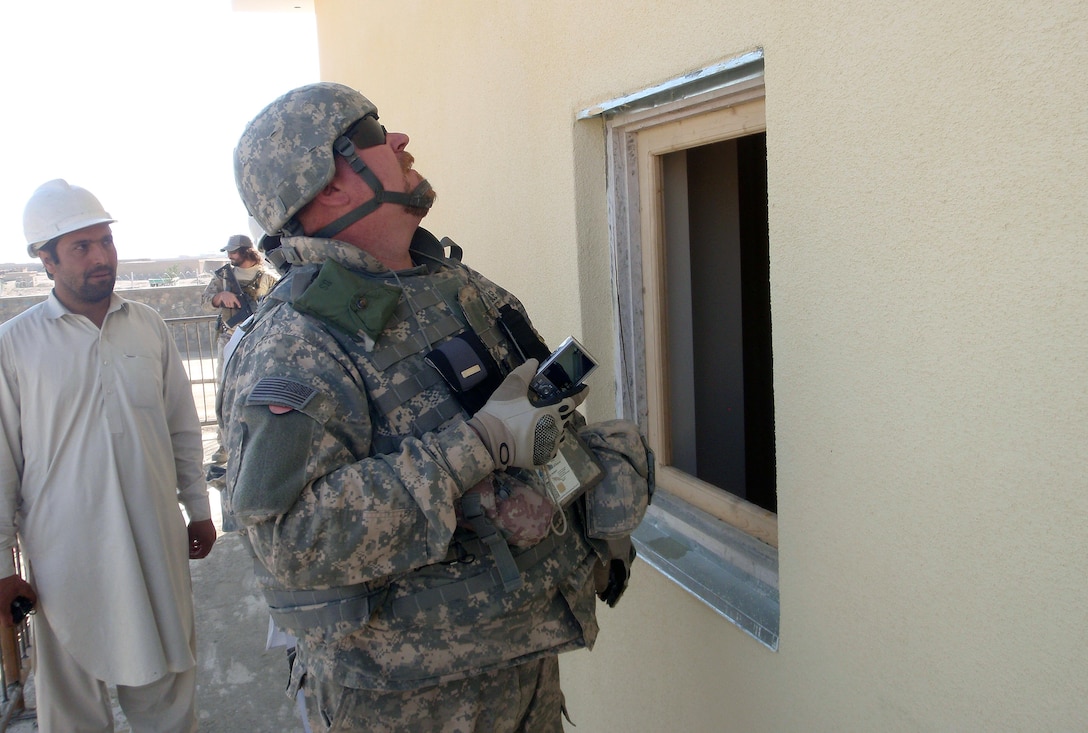 Chuck Hadley inspects a window frame installation in a Paktya Province police facility project. (U.S. Army Corps of Engineers photo by Lt. Col. Bart Kemper/released)