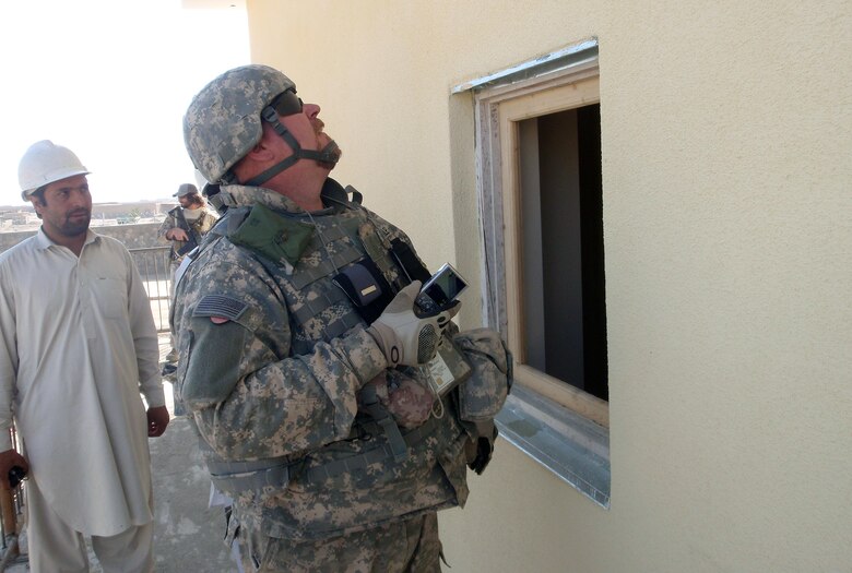 Chuck Hadley inspects a window frame installation in a Paktya Province police facility project. (U.S. Army Corps of Engineers photo by Lt. Col. Bart Kemper/released)