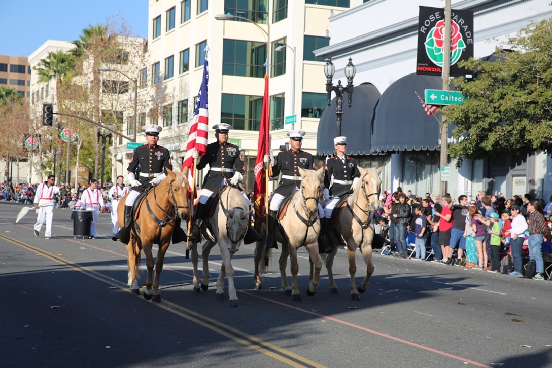Sergeant Moises Machuca (left), stableman with the Marine Corps Mounted Color Guard on Marine Corps Logistics Base Barstow, Calif., rides in his first big event with the MCG during the Rose Parade, Jan 1. Machuca used training with Scout Snipers to understand and learn horsemanship.


