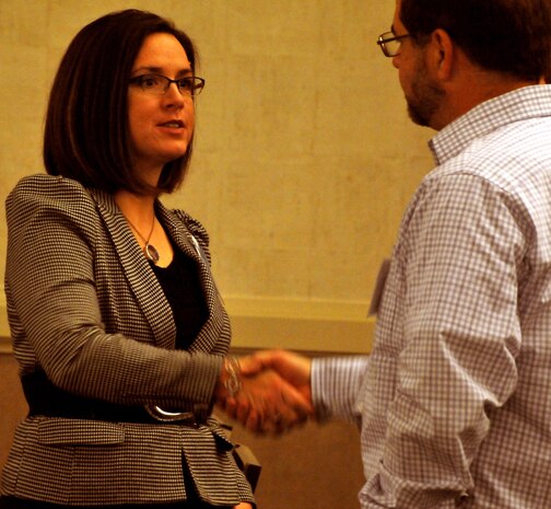 Jennifer McDowell, U.S. Army Engineering and Support Center, Huntsville interior designer, shakes hands with a representative from the furniture vending industry during the Furnishing Program's Centralized Furnishings Industry Day, Feb. 27, in Huntsville, Ala. More than 40 Furnishings Program representatives, including project managers, contracting officials and interior designers, were on hand to answer questions about the program. In FY13, the Furnishings Program furnished 209 administrative buildings and 262 barracks buildings, which included 26,601 barracks spaces, for a program cost of $132 million, with a total cost avoidance of $26 million, or 19 percent of the estimated value of the program.