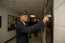 Master Gunnery Sergeant (retired) Jimmy Hargove of the Montford Point Marines Association looks over one of the displays at the dedication ceremony for the new Montford Point Marines Memorial wall at the Center for Naval Aviation Technical Training Unit aboard Naval Air Station Oceana, Va 21 February, 2014. The memorial wall is dedicated to the service of the Montford Point Marines who in 1941 were the first African Americans to join the U.S. Marine Corps.