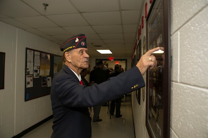 Master Gunnery Sergeant (retired) Jimmy Hargove of the Montford Point Marines Association looks over one of the displays at the dedication ceremony for the new Montford Point Marines Memorial wall at the Center for Naval Aviation Technical Training Unit aboard Naval Air Station Oceana, Va 21 February, 2014. The memorial wall is dedicated to the service of the Montford Point Marines who in 1941 were the first African Americans to join the U.S. Marine Corps.