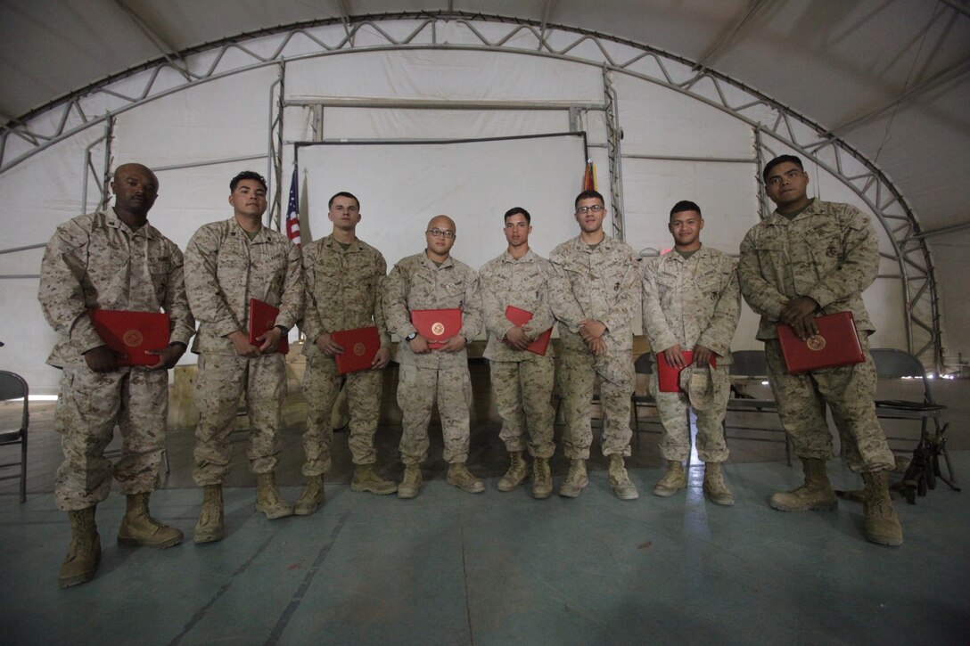 Leatherneck, Helmand Province, Afghanistan – Captain Henry Bouchot, judge advocate, 3rd Battalion, 7th Marine Regiment, stands with Marines serving with various different units deployed to Camp Leatherneck, Helmand province, Afghanistan, after the earn their United States citizenship during a naturalization ceremony aboard the base. The Marines were excited to not only be serving as the few, the proud, but also to finally have reached their goal of becoming U.S. citizens.