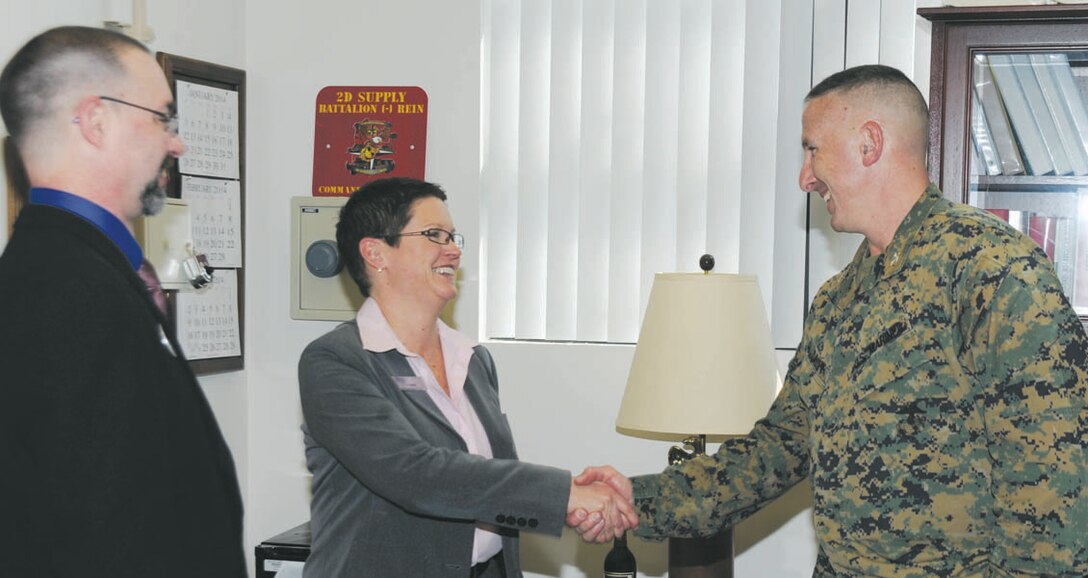 Col. Don Davis, commanding officer, Marine Corps Logistics Base Albany, thanks Connie Schauer, branch head, Navy Federal Credit Union, after he signs the Military Saves Week proclamation during a ceremony held Monday. Also in attendance was James Carey Snipes, personal financial management, Marine Corps Community Services. Military Saves Week ends Saturday. According to the website, http://military saves.org, Military Saves Week is a time to review finances, decide what to save for, and set up a system that will allow an individual to save automatically. Schauer said NFCU will observe Military Saves Week through March 25.