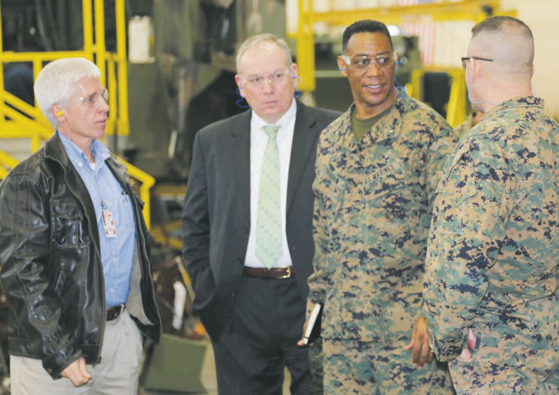 Brig. Gen. Craig C. Crenshaw, (center) assistant deputy commandant for Installations and Logistics (Plans), speaks to Col. Jeffrey Hooks, commander, Marine Depot Maintenance Command, during a recent tour of Production Plant Albany, while Darren Jones, (left) plant manager, PPA, and Michael Madden, executive deputy, Marine Corps Logistics Command, listen.