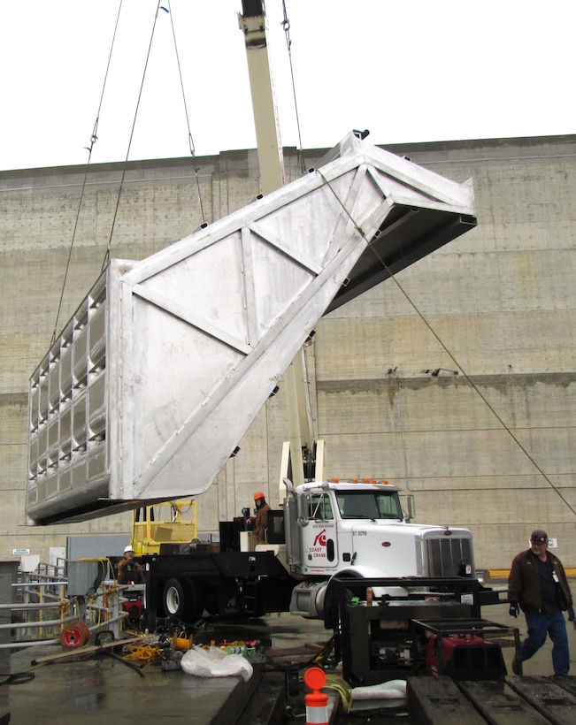 It takes a team of riggers and a strong crane to lower the entrance hood of McNary Lock and Dam’s prototype lamprey-passage structure  into the Oregon shore fish ladder. 