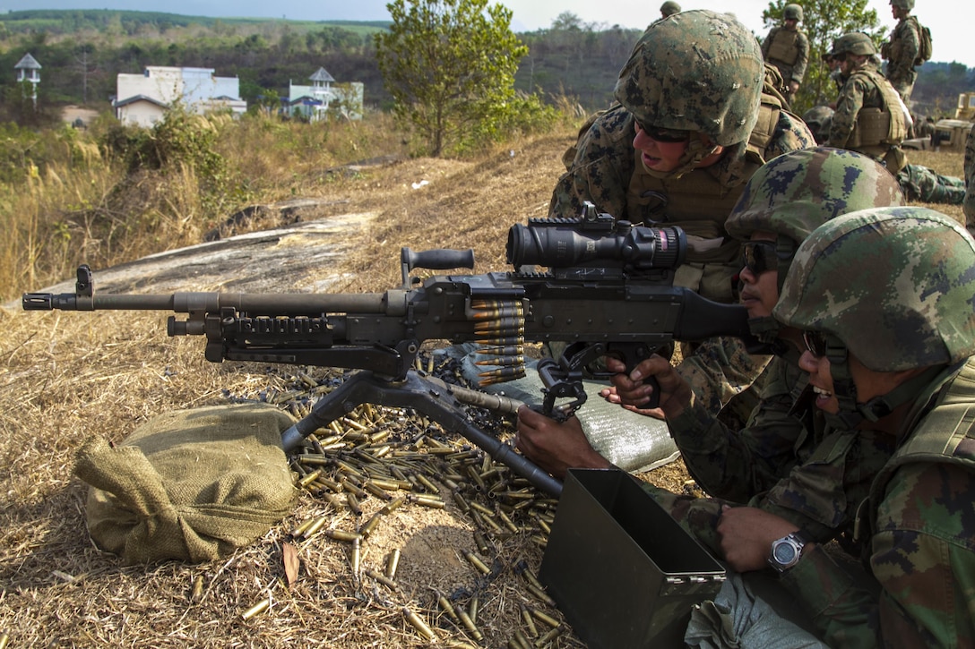 Lance Cpl. Johnathan Ziolek, a Walton, IN native, talks Thai Private Poempoon Kanjanapakornchai onto the target while firing M240B Medium Machine gun Feb. 12 at Ban Chan Krem, Kingdom of Thailand during Exercise Cobra Gold. Cobra Gold is designed to advance regional security and ensure effective response to regional crises by exercising a robust multinational force from nations sharing common goals and security commitments in the Asia-Pacific Region. Kanjanapakornchai and the Royal Thai Marines are with 3rd Company, 7th Battalion, Royal Thai Marine Corps. Ziolek is a machine-gunner with Weapons Company, 3rd Battalion, 1st Marine Regiment currently assigned to 4th Marine Regiment, 3rd Marine Division, III Marine Expeditionary Force under the unit deployment program.