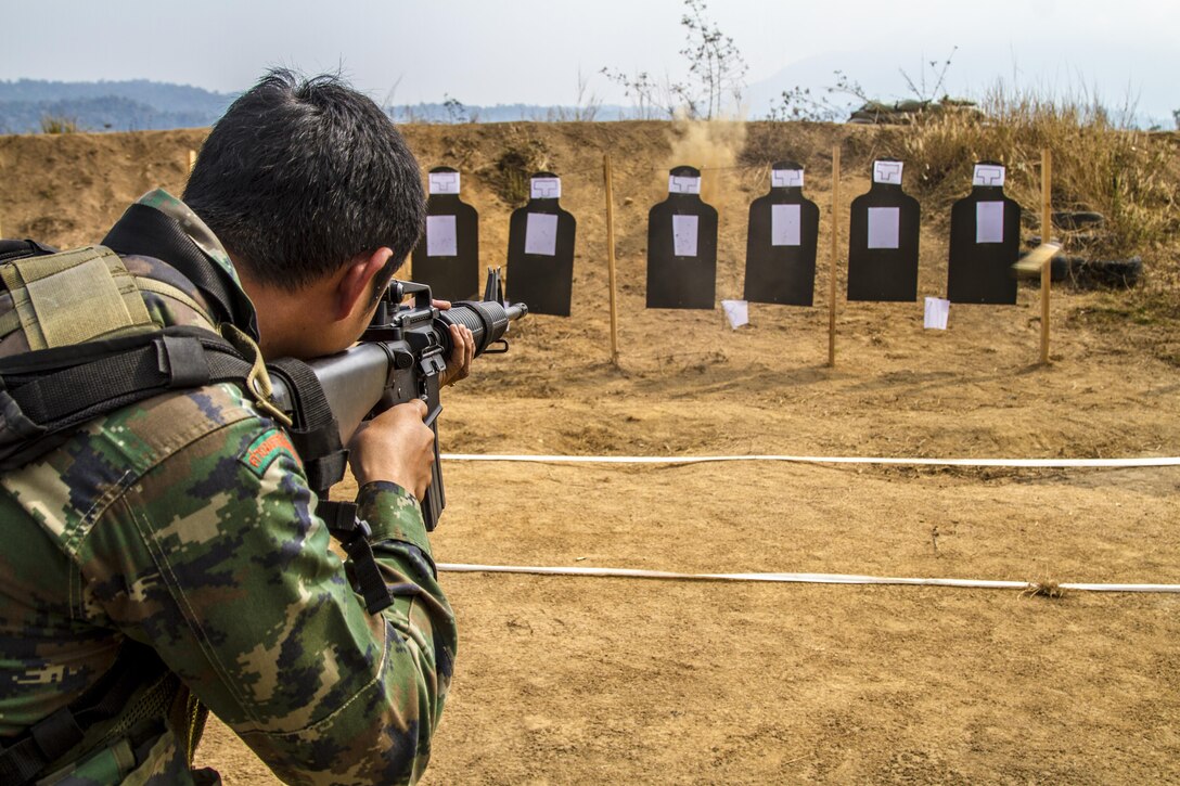 Petty Officer 2nd Class Patchara Somkittitham demonstrates the course of fire for a modified table 3 and 4 Feb. 15 at Ban Chan Krem, Kingdom of Thailand during Exercise Cobra Gold 2014. Thailand and the United States are committed to working together in areas of common interest for the betterment of regional security. The long-standing alliance and partnership continues to grow and strengthen. Somkittitham is a rifleman with 3rd Company, 7th Battalion of the Royal Thai Marine Corps. The U.S. Marines are with Lima Company, 3rd Battalion, 1st Marine Regiment currently assigned to 4th Marine Regiment, 3rd Marine Division, III Marine Expeditionary Force under the unit deployment program.
