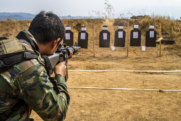 Petty Officer 2nd Class Patchara Somkittitham demonstrates the course of fire for a modified table 3 and 4 Feb. 15 at Ban Chan Krem, Kingdom of Thailand during Exercise Cobra Gold 2014. Thailand and the United States are committed to working together in areas of common interest for the betterment of regional security. The long-standing alliance and partnership continues to grow and strengthen. Somkittitham is a rifleman with 3rd Company, 7th Battalion of the Royal Thai Marine Corps. The U.S. Marines are with Lima Company, 3rd Battalion, 1st Marine Regiment currently assigned to 4th Marine Regiment, 3rd Marine Division, III Marine Expeditionary Force under the unit deployment program.