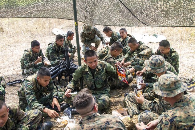 During lunch Royal Thai Marines trade meals with U.S. Marines as they share stories and get to know each other on a personal level Feb. 15 at Ban Chan Krem, Kingdom of Thailand during Exercise Cobra Gold 2014. Cobra Gold demonstrates the U.S. and the Kingdom of Thailand’s commitment to a long-standing alliance in the Asia-Pacific region to continue to promote increased prosperity and security. The Thai Marines are with 3rd Company, 7th Battalion with the Royal Thai Marine Corps. The U.S. Marines are with Lima Company, 3rd Battalion, 1st Marine Regiment currently assigned to 4th Marine Regiment, 3rd Marine Division, III Marine Expeditionary Force under the unit deployment program. 