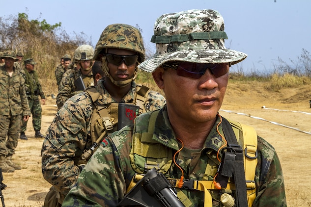 Royal Thai Marines and U.S. Marines line up for a pivot drill while firing a modified table 3 and 4 at Ban Chan Krem, Kingdom of Thailand during Exercise Cobra Gold 2014. Exercise Cobra Gold is a multinational and multiservice exercise that takes place annually in the Kingdom of Thailand and was developed by the Thai and U.S. militaries. The Thai Marines are with 3rd Company, 7th Battalion with the Royal Thai Marine Corps. The U.S. Marines are with Lima Company, 3rd Battalion, 1st Marine Regiment currently assigned to 4th Marine Regiment, 3rd Marine Division, III Marine Expeditionary Force under the unit deployment program. 