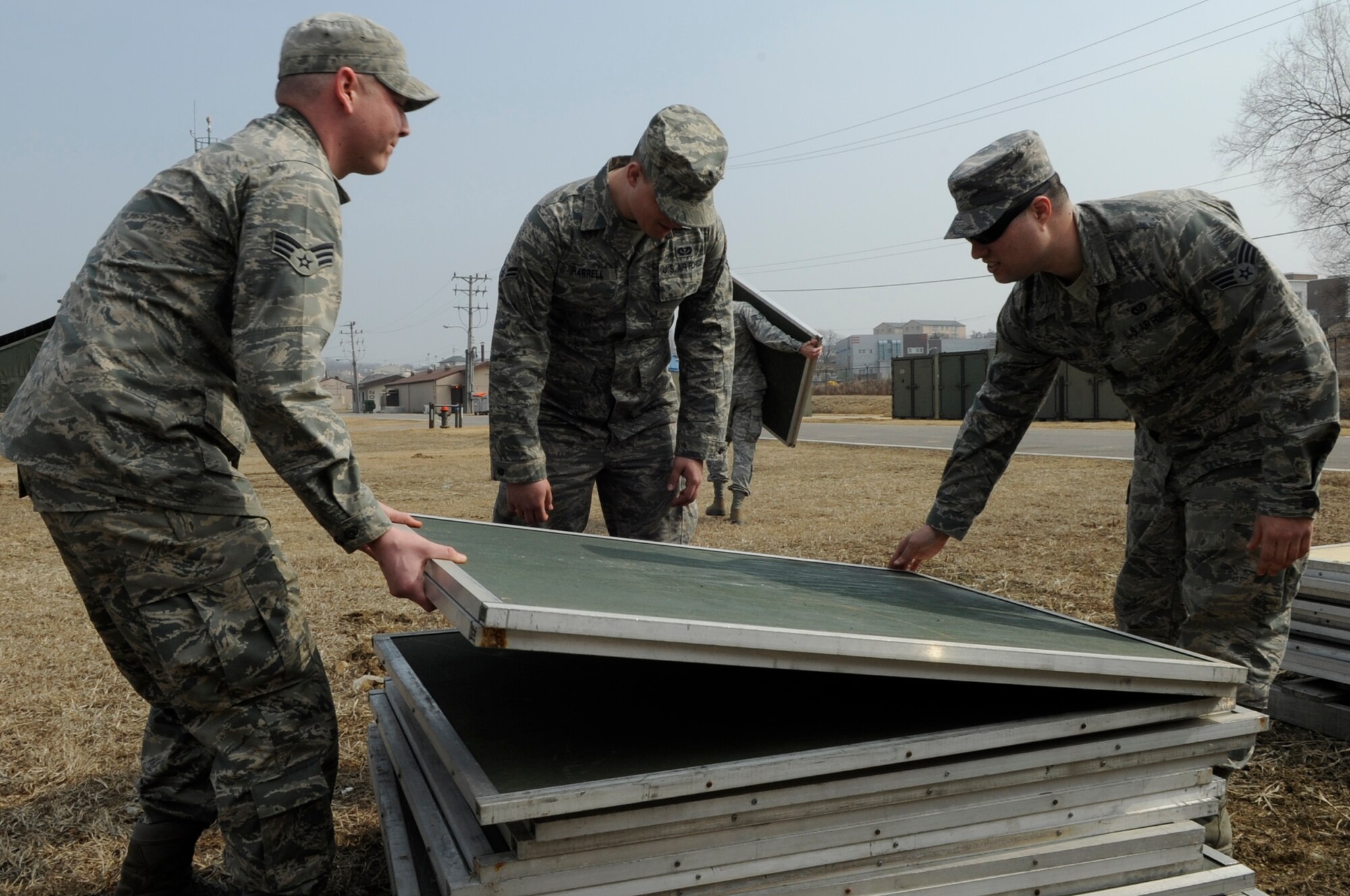 Members from the 35th Civil Engineer Squadron from Misawa Air Base, Japan, move storage container shelves for spare parts during Exercise Key Resolve 2014 at Osan Air Base, Republic of Korea, Feb. 27, 2014. The 35 CES maintains approximately $6 million of equipment for augmenteees residing in tent city. (U.S. Air Force photo/Senior Airman Marcus Morris)
