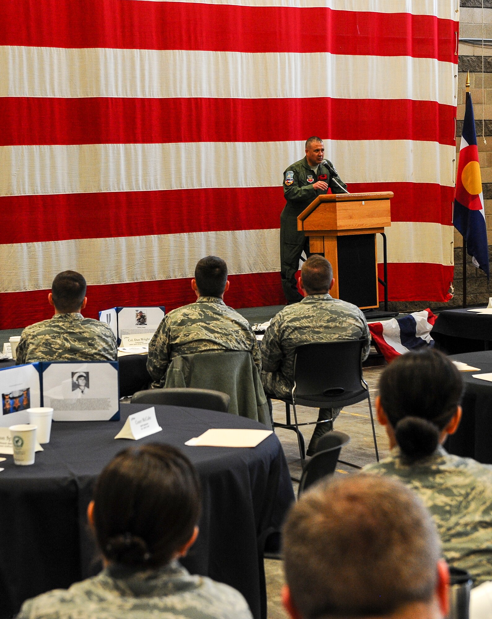 Col. Floyd Dunstan, 140th Wing commander, addresses base and community members at the monthly Aurora Defense Council meeting Feb. 27, 2014, at the Navy Operational Support Center Denver facility on Buckley Air Force Base, Colo.  The meeting included a briefing from base partner commanders, local and state organizations, and an unmanned aerial vehicle demonstration by Falcon UAV. (U.S. Air Force photo by Senior Airman Phillip Houk/Released)  