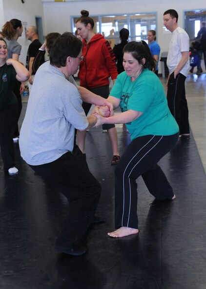 Don Geertz, 341st Civil Engineer Squadron member (left), and his class partner, Nina Redenius, Malmstrom dependent, practice a wrist-release technique taught at the Gracie Defense System kickoff seminar at the base fitness center Feb. 22. During the seminar, participants were able to see and try a few techniques with each other. (U.S. Air Force photo/Senior Airman Cortney Paxton)