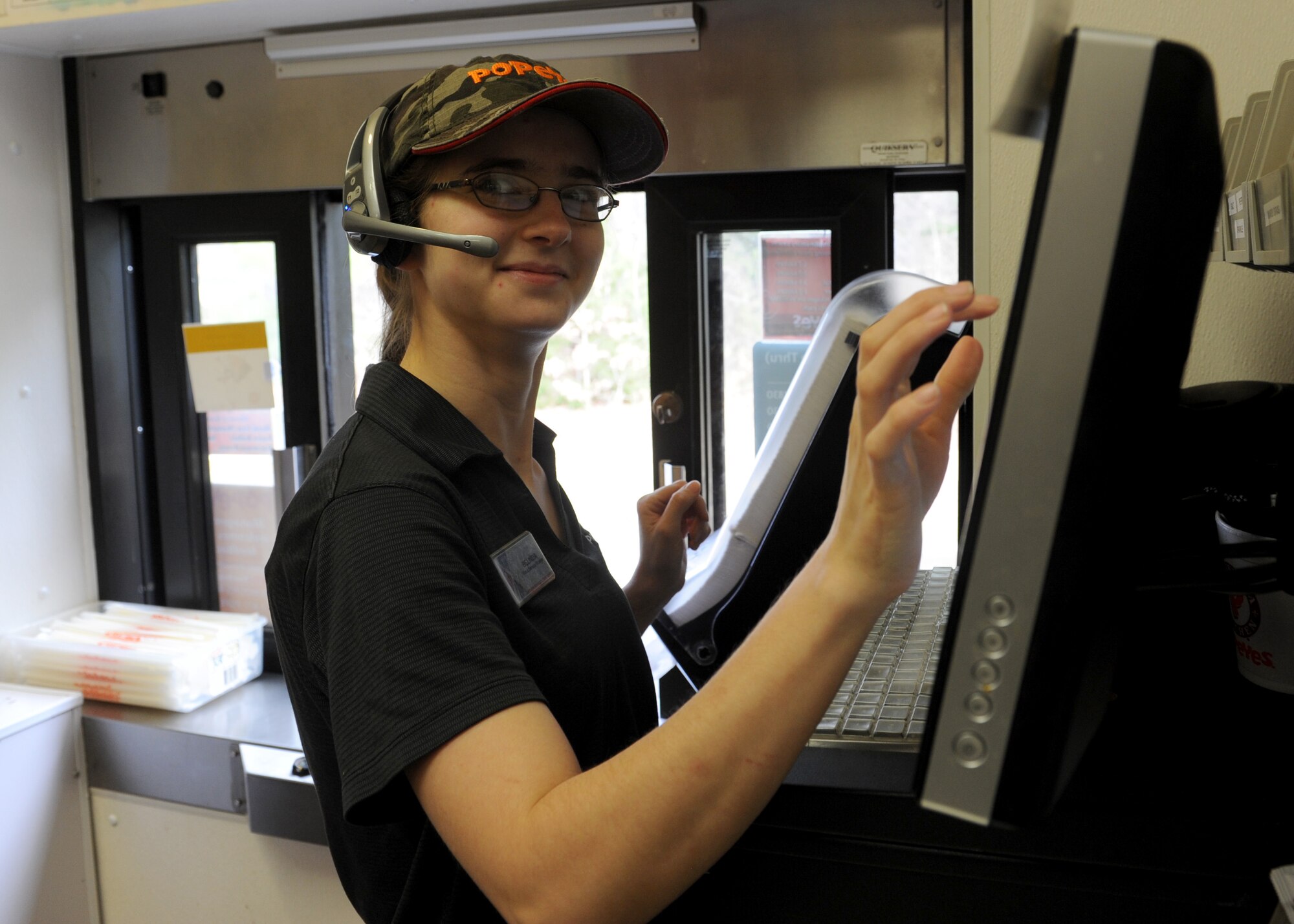 Belinda Brown, an Army and Air Force Exchange Services Popeye’s food service foreman, takes an order at the drive-thru Feb. 24, 2014, at Little Rock Air Force Base, Ark. Brown’s hard work helped Popeye’s finish as the No. 1 store with the fastest drive-thru speed throughout AAFES for 2013. (U.S. Air Force photo by Airman 1st Class Scott Poe)