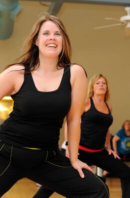 Susie Macdonald, Zumba instructor, leads a class in a post-workout stretch at the Riptide Gym on Hurlburt Field, Fla., Feb. 2, 2014. Macdonald said she was inspired to become a Zumba instructor after she lost 76 pounds as a Zumba student. (U.S. Air Force photo/Airman 1st Class Andrea Posey)