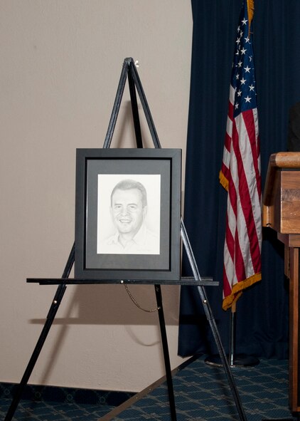Colonel Andrew Croft 49th Wing commander, unveils new Holloman Wingman Bobby Martinez, CEO and president of Desert Sun Motors, portrait during the Civic Leaders Reception at the Holloman Air Force Base, N.M.,  Desert Sands Enlisted Club, Feb. 25. This event helps to increase public awareness and understanding of the armed forces to include the missions, policies, programs and people assigned to Holloman. Team Holloman leadership and community leaders gathered and showed support as a new member of the Holloman Wingman was inducted. (U.S. Air Force photo by Senior Airman Colin Cates/Released)

