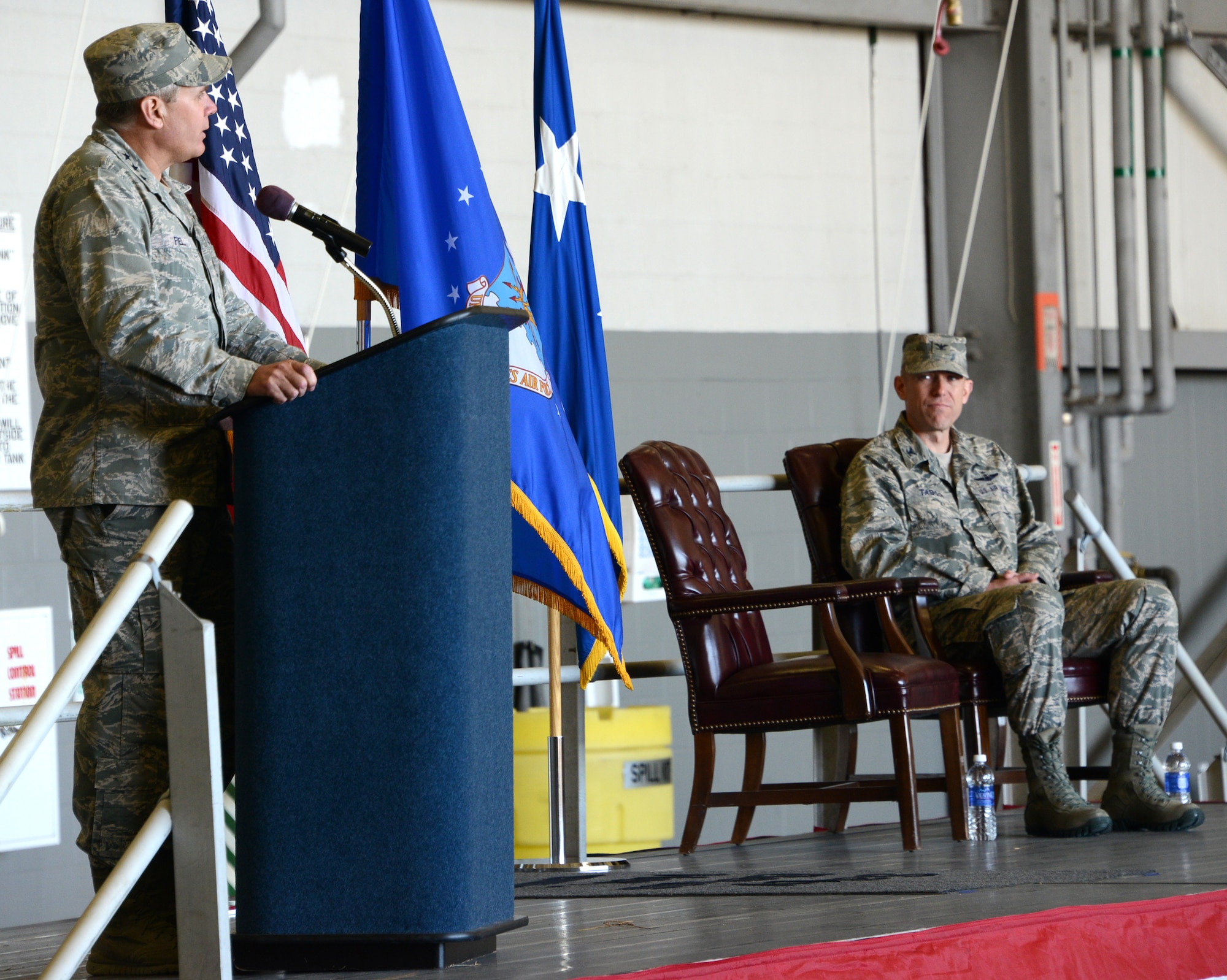 Lt. Gen. Eric Fiel, Air Force Special Operations Command commander gives opening remarks while Col. David Tabor listens during the Air Force Special Operations Air Warfare Center assumption of command ceremony held at Duke Field, Fla., Feb. 27, 2014.  Tabor took command of AFSOAWC. (U.S. Air Force photo by Master Sgt. Steven Pearsall)   